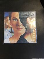 Front cover of Styx Pieces of Eight vinyl LP in shrink wrap showing artwork with three women's faces.