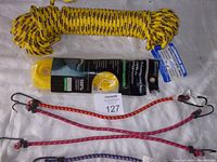 Top view of the yellow 75 ft polyethylene rope and four bungee cords in different colors arranged below it