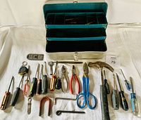 Photo of the metal toolbox with all hand tools displayed in front showing screwdrivers, pliers, scissors, hammer, Allen keys, magnet, tape measure, scraper and other items