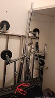 Photo showing three chrome metal clothing racks stacked together, highlighting the tubular metal frame and wheels used for mobility.