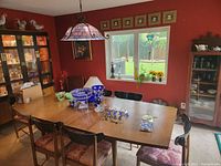 Full set overview showing table with temporary decorative items and all six chairs