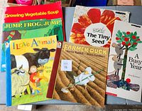 Photo showing six large children's books in fair condition with colorful illustrated covers.