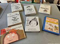 7 children's hardcover poetry books spread out on a table, including multiple Shel Silverstein titles and a boxed set 'Ready, Set, Read!'