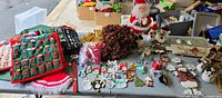Wide view of the Christmas decorations showing Advent calendars, ornaments with snowmen and Santa figures, a decorative wreath, and a Christmas tree bag