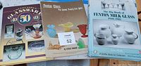 Photo showing three books about Fenton Glass collecting, titles visible and covers showing various collectible glass items, including milk glass and colored glass pieces.