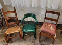 Three vintage small children's chairs together, showing overall wear and different styles.