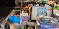Photo of stationary lot items including multiple clipboards, plastic organizers, label packages, and file tote case