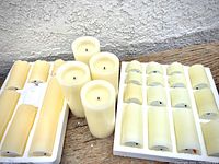 Three candle sets displayed: 4 tall battery-operated wax-like candles, 8 medium candles in foam tray, and boxed set of 20 small tealight flameless candles.