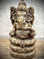 Front view of Ganesha statue showing detailed carving and gold accents.