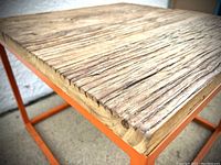 Close-up of the thick solid reclaimed wood tabletop showing natural wood grain and texture.