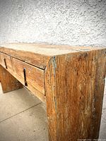 Front-left perspective showing overall design, three drawers, and distressed finish.