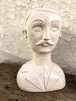 Close-up of male bust planter showing facial detail and ceramic finish