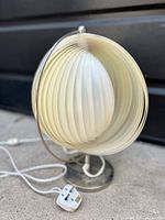 Photo of a retro swirl table lamp with an acrylic shade and UK plug showing slight discoloration.