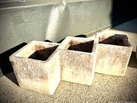 Hexagonal natural stone planter with rough texture and natural coloration.