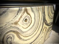 Close-up of resin surface showing swirling geode pattern in neutral tones