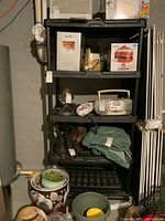 Full view of shelving unit with five shelves showing various items stored, illustrating the unit's use and structure.