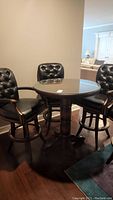 Overall view of round pub table and four bar stools