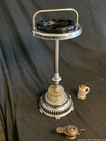 Overall view of chrome ashtray with marble base, black glass insert and two lighters