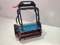 Front view of the Gardena 380C push reel mower showing handle, wheels, and cutting reel.