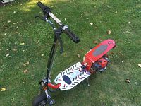 Side view of scooter showing deck, engine and front wheel