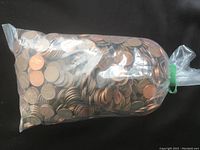Bag filled with American pennies showing quantity and general appearance.