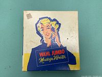 Top view of the vintage original box showing WAHL Jumbo Massage Vibrator logo with graphic of a woman using the device.