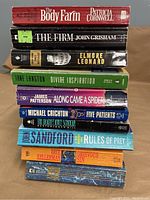Stack of 10 mystery paperback books showing worn spines and titles