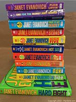 Spine view of 11 Janet Evanovich Stephanie Plum books showing titles and colorful design