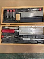Two hobby tool sets including multiple blades, knives and handles in their trays.