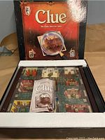 Clue Collectors Edition board game box open showing the colorful mansion game board and instruction booklet inside.
