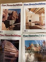 Four Fine Homebuilding magazine issues showing covers with home and architectural photography including stone fireplaces, modern interiors, rustic wood construction, and classic houses.