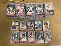 Stacked baseball cards organized by team sets, with player photos visible on card fronts, showing players from major league teams in 1988-1989 seasons.