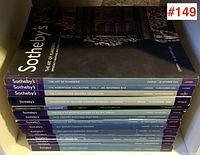 Stack of fifteen Sotheby's auction catalogues showing front cover of 'The Art of Flanders' and spines of other catalogues