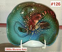 Top-down view showing turquoise-green interior with gold flecks and red-amber swirl