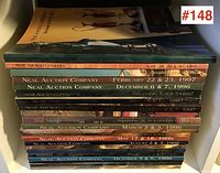 Photo showing side view of 22 stacked Neal Auction Company catalogues with various auction dates from 1994 to 1997.