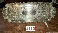 Full overhead view of the rectangular silver plate tray showing embossed decorative surface and handles.
