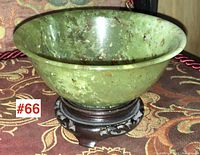 Front view of jade bowl seated on wooden stand