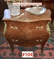 Angled frontal view showing overall form, marble top with decorative objects excluded from sale