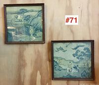 Pair of framed Asian prints hung on a wall showing two separate prints with traditional Japanese-style imagery.