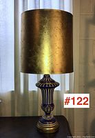 Full view of lamp with gold leaf finish shade