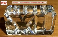 Top view showing the Roman numeral XII deeply cut in crystal, clear with beveled edges.