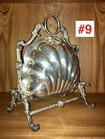 Three-quarter front view of warming server showing scalloped insert and ornate frame.