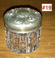 Front angle showing cut crystal jar and embossed sterling silver lid.
