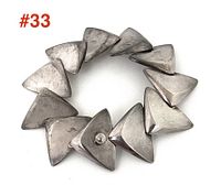 Top-down view of assembled bracelet arranged in a circle showing overall modernist design