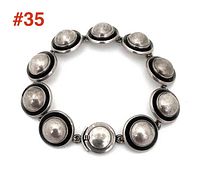 Top view of bracelet laid flat showing ten domed circular links and box clasp