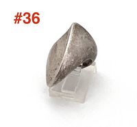 Front view of ring on clear stand showing overall sculptural form and patina