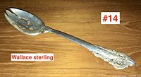 Full view of the serving spoon showing bowl and handle, marked 'Wallace sterling'