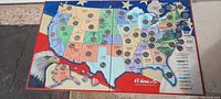 Full view of the colorful map folder showing all 50 states with quarters placed in most state slots.