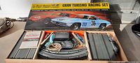 Complete Gran Turismo Racing Set with cars, track, controllers, and power pack in original box.