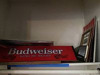 Budweiser red hanging light sign with white lettering